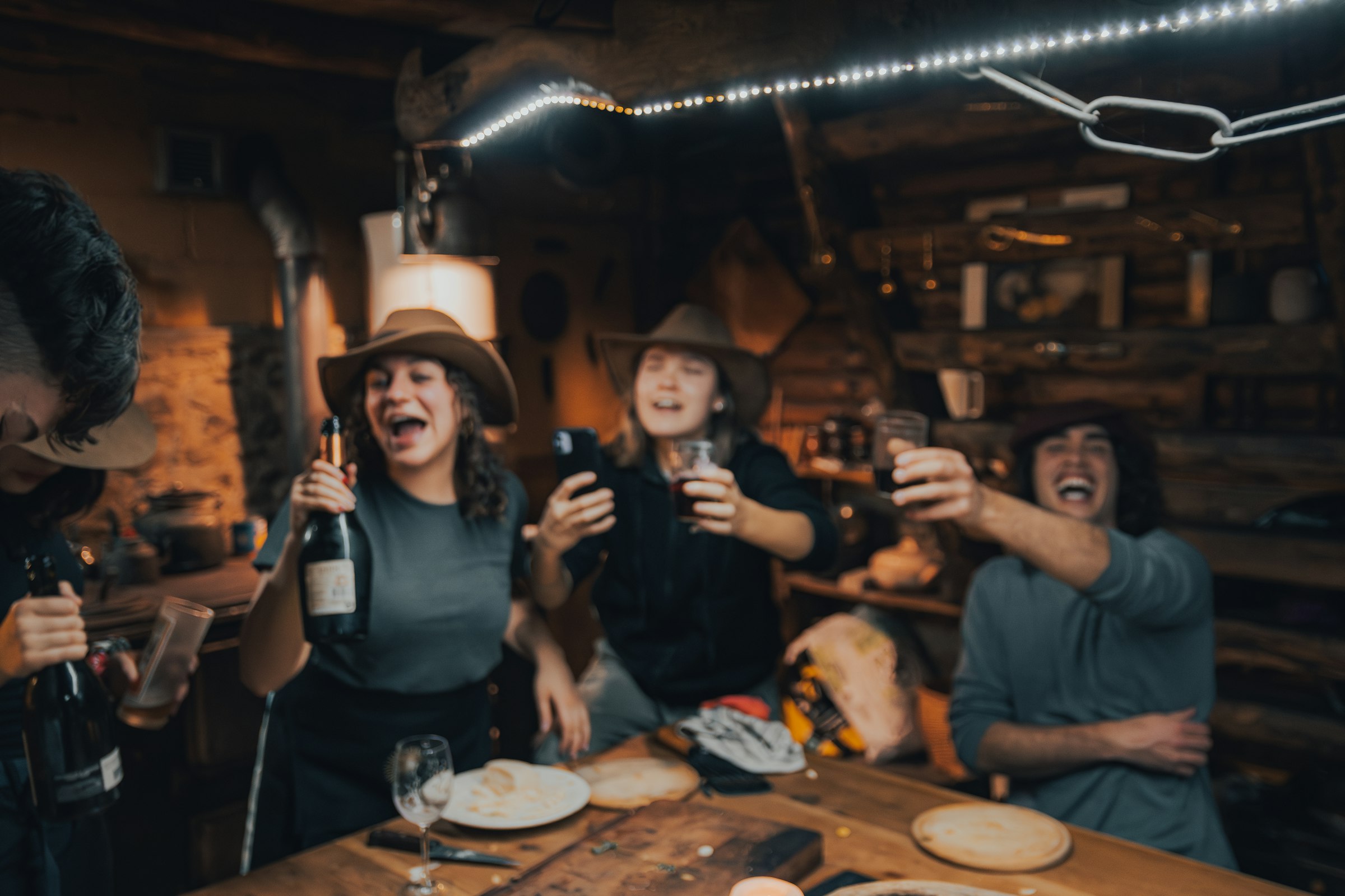 Friends laughing and raising a toast around a table